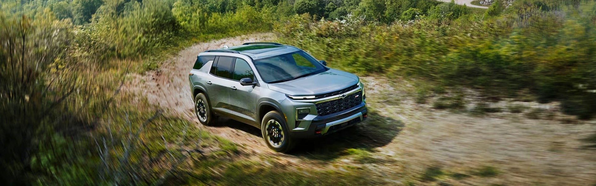 Gray chevy traverse running in jungle area