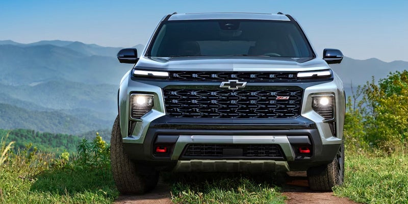 Gray chevy traverse doing offroading in mountain area