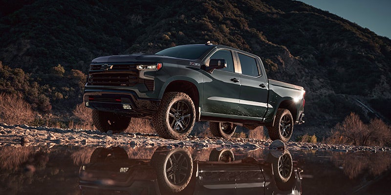 gray chevy silverado running near river section