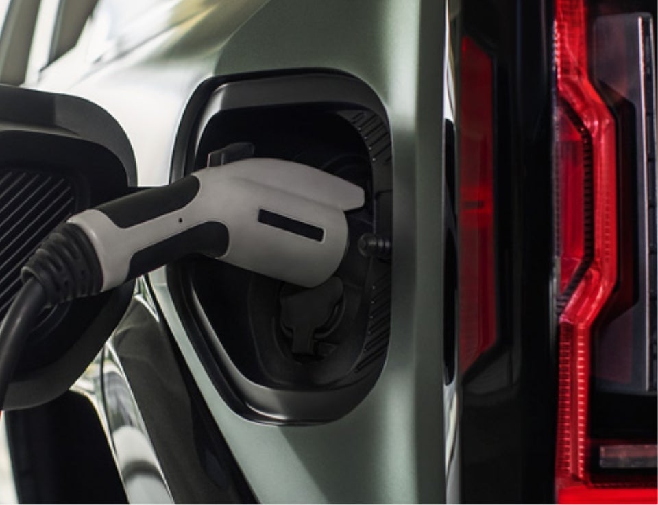 Close up of charging port with charger plugged in on a GMC Hummer EV SUV - Dublin Chevrolet GMC in DUBLIN GA