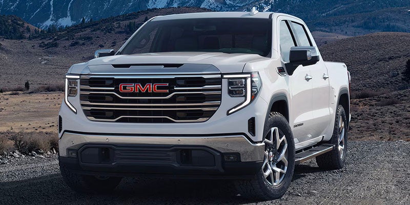 white gmc standing in hills