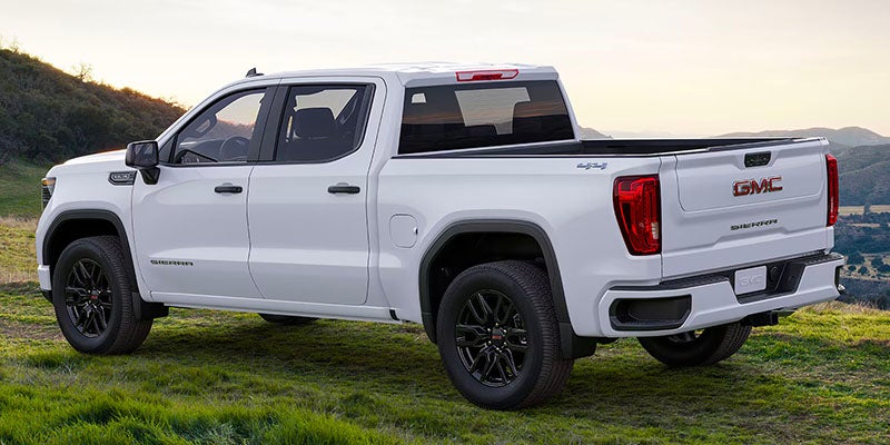 white gmc standing in mountains